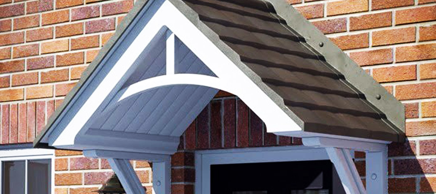 A white duo pitch door canopy with a grey roof installed above the front door of a house